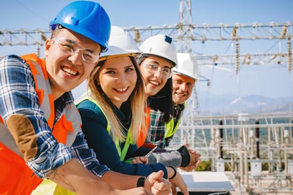 Young engineering apprentices in hardhats on a building services construction site
