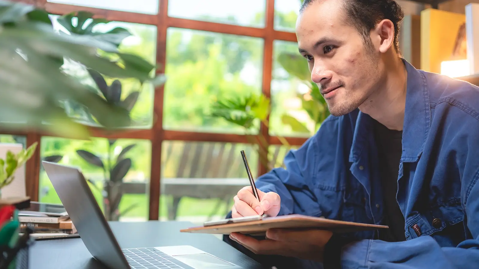 Building services employee completing online training on a laptop