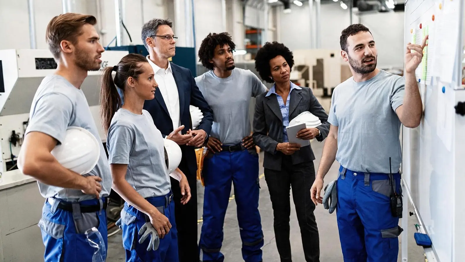 Building services employees and managers planning workforce training in a technical workshop