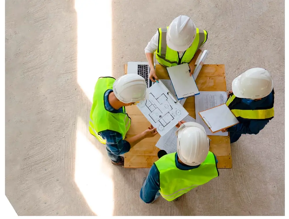 Construction professionals reviewing plans on site to support SKEB competence and compliance under the Building Safety Act